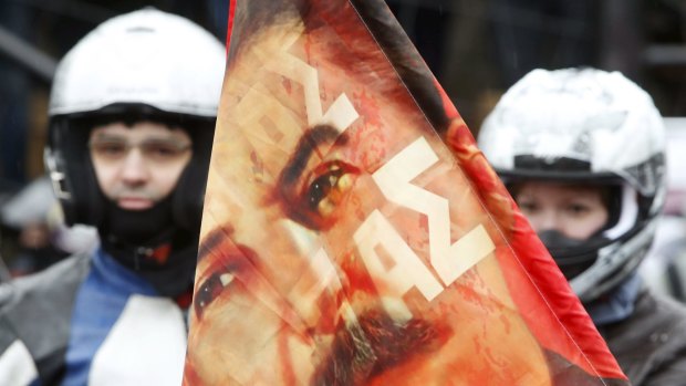 Bikers gather near a flag showing a portrait of Soviet leader Joseph Stalin before a farewell ceremony to see off the riders.