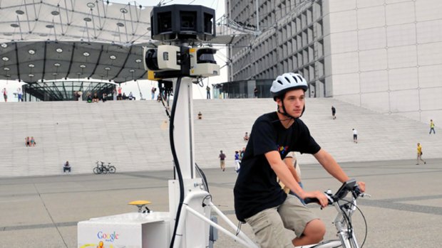 Arthur Poirier, a French student employed by Google France, rides a tricycle fitted with cameras as part of the Google Street View project.