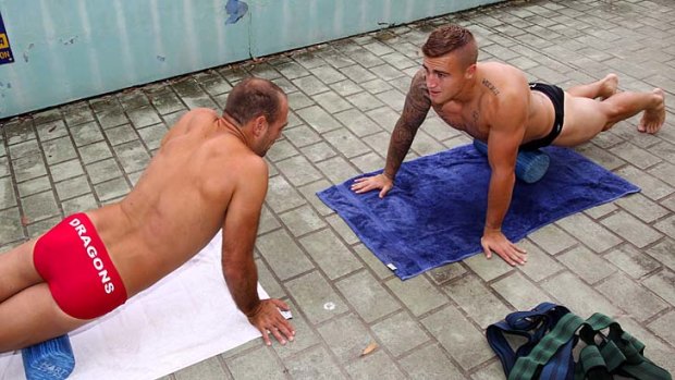 Downward Dragons: Replete in St George Illawarra-issue budgie smugglers, Jason Nightingale chats with a similarly attired Cameron King during recovery at North Cronulla this week. The flexible pair will hope to get their side's season on a roll come Friday night against Brisbane.