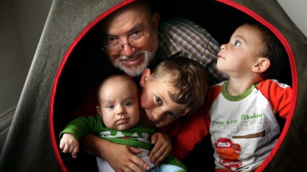 Time is on our side: Peter Farrugia, 64, with grandchildren Noah, Jude and Cooper. The risk of dying at all ages between 0 and 80 has fallen.