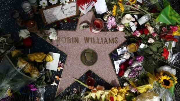 A floral tribute at the Hollywood star of Robin Williams.