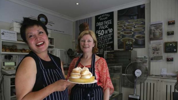 Let them eat gluten-free cake ... the owners of Healthy Feast bakery in Leichhardt, Silvia Philips, left, and Kim McGlinn, show off one of their products.