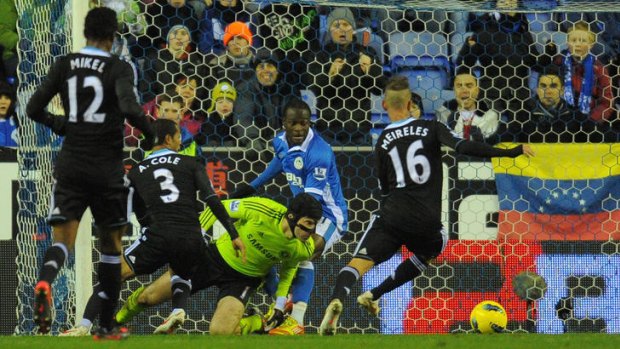 Blunderball ... Chelsea's goalkeeper Petr Cech loses the ball in the lead up to Jordi Gomez's equaliser for Wigan.