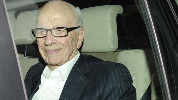 Storm ... News Corp chairman Rupert Murdoch arrives at his apartment in London.