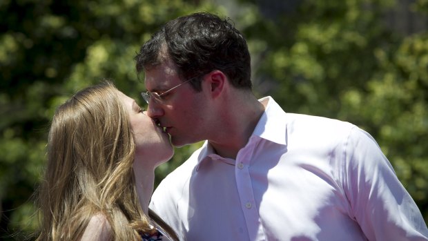 Chelsea Clinton kisses her busy investment banker husband Marc Mezvinsky. 
