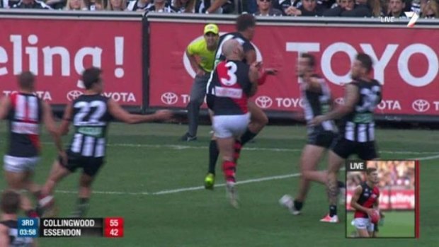 Collingwood's Clinton Young bumps Essendon's Paul Chapman at the MCG on Anzac Day. 