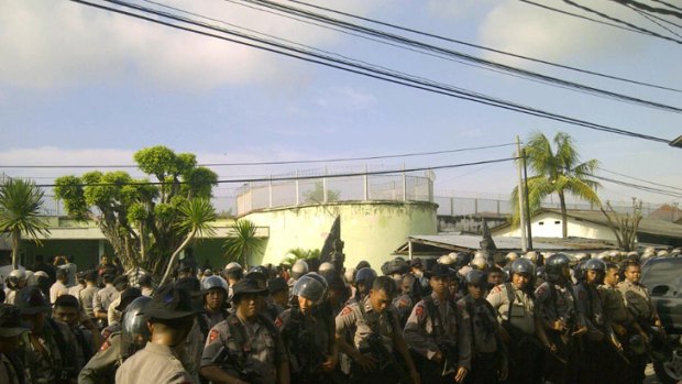 'Under control' ... Police outside the Kerobokan jail, where inmates are said to have been overpowered.