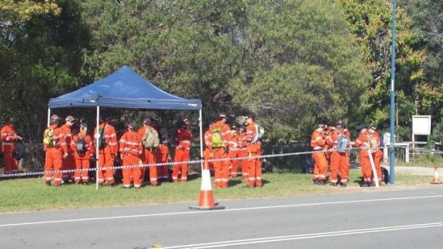 Gold Coast SES volunteers search for a weapon after Mark Emanuel Spencer was killed at Coomera.