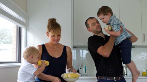Pressed for time ... publicist Belinda West and electrician husband Greg with sons Harry, 3, and Archie, 1, in the kitchen of their Lugarno home.