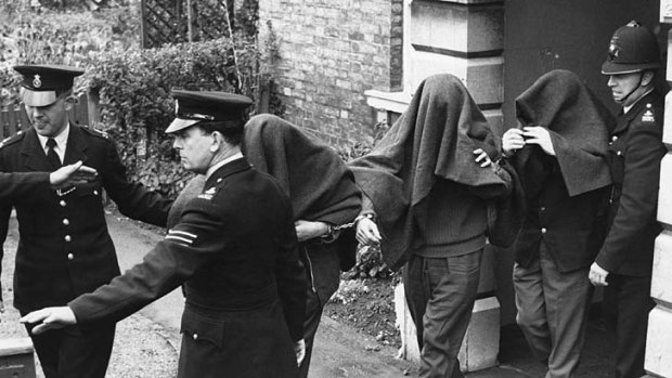 Three of the suspects arrested in connection with the Great Train Robbery leave court with blankets over their heads.
