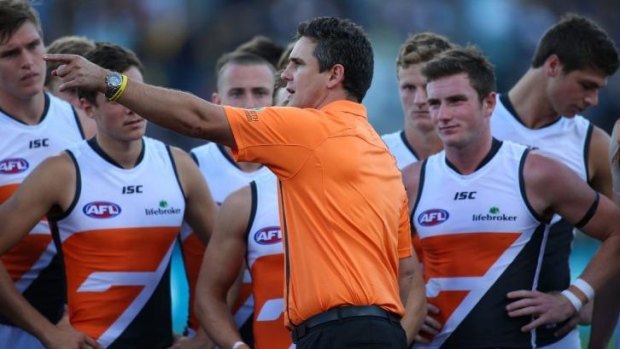 GWS coach Leon Cameron speaks to his players at three-quarter-time during the match against West Coast on Sunday.