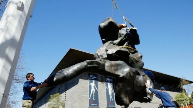 On the move: Workers place on flat bed truck the Williem de Kooning's sculptue <i>Standing Figure</i> in a four hour operation to move it from the forecourt of the Victorian Arts Centre. 