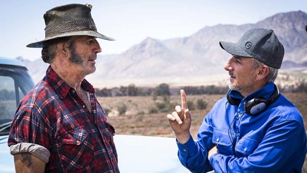 Menacing psychotic ... John Jarratt, left, on the outback set of Wolf Creek 2 with the director Greg Mclean.