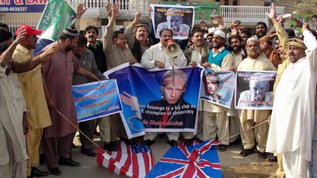 Sign of the times: Pakistani protesters display posters before burning US and British flags.