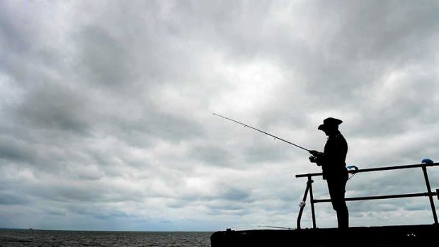 Khodar Assaad fishes off Altona Pier under grey skies.