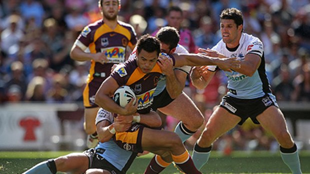 Who's watching? ... Ben Te'o is tackled at Suncorp Stadium this afternoon.
