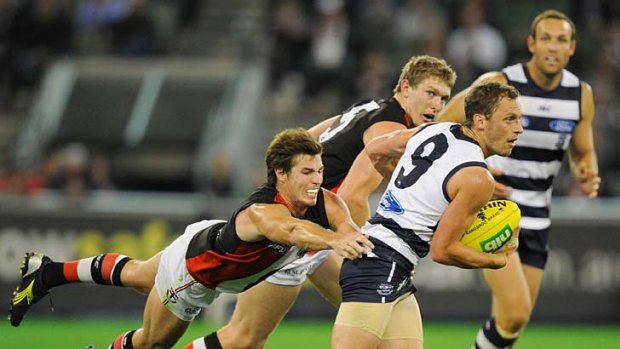 Desperate times: St Kilda's Lenny Hayes makes a diving lunge at Geelong's James Kelly.