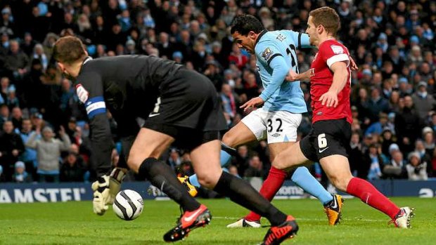 Carlos Tevez of Manchester City scores the opening goal.