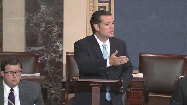 US Senator Ted Cruz, denounces "Obamacare" as he speaks on the Senate floor on Capitol Hill in Washington during his marathon effort.