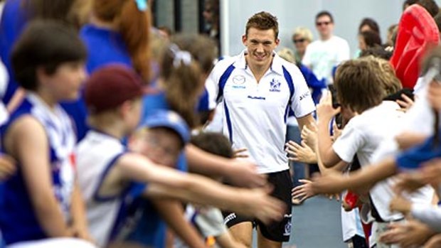Drew Petrie greets fans during the North Melbourne family day yesterday.