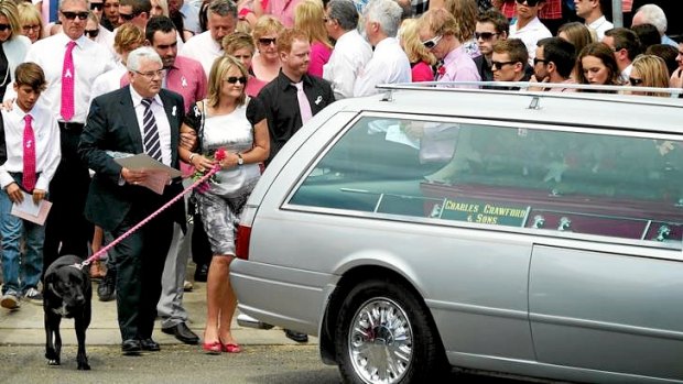 Sarah's funeral ... her mother Noelle Dickson leaves St Andrews Uniting Church with Sarah's dog Sprockett.