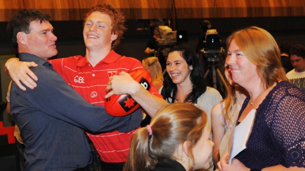 Gary Rohan is congratulated by his father Jim after being drafted by Sydney on Thursday night.