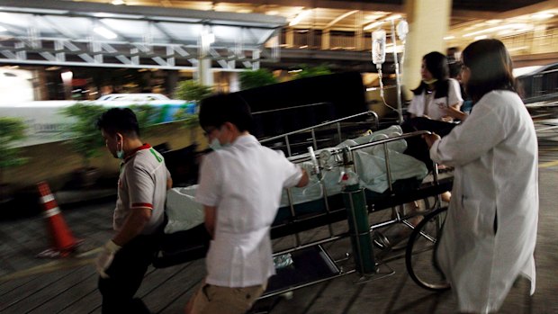 Medical workers rush a victim of a blast at the Erawan Shrine to a nearby hospital in central Bangkok.