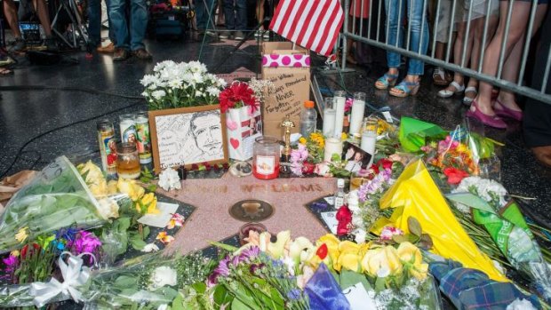 Flowers are placed on Robin Williams Hollywood Walk of Fame star.