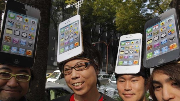 Apple fans in Tokyo line up for the launch of the iPhone 4S.
