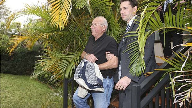 Handcuffed: Detectives arrest Roger Rogerson.