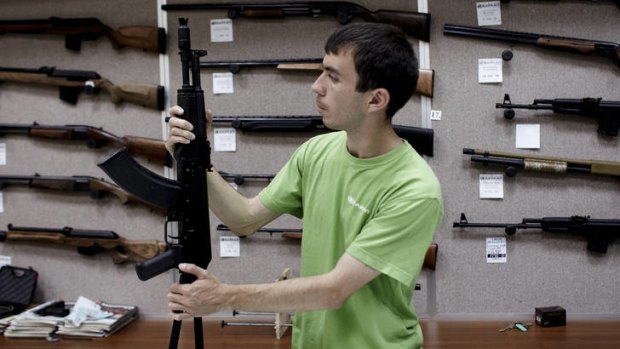 A prospective buyer inspects a Saiga, also known as the Kalashnikov, among a rack of weapons in Izhevsk, Russia. But it's the US that beckons Kalashnikov.