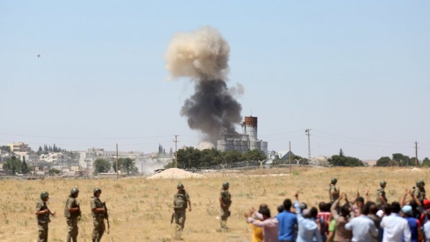 Smoke rises in the Syrian town of Kobane this week after Islamic State fighters launched simultaneous attacks against the Syrian government and Kurdish militia.