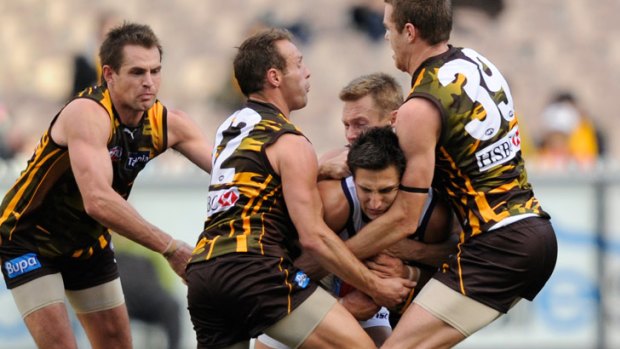 Pavlich is overcome by tackle from the Hawks over the weekend.