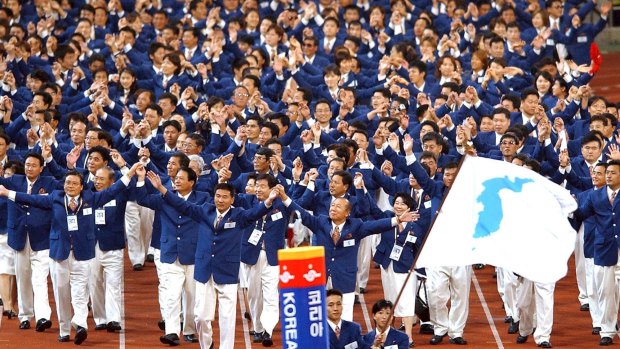 Athletes from North and South Korea march together, led by a unification flag during opening ceremonies for the 14th Asian Games in Busan, South Korea in 2002 when they conducted a joint march during the opening and closing ceremonies.