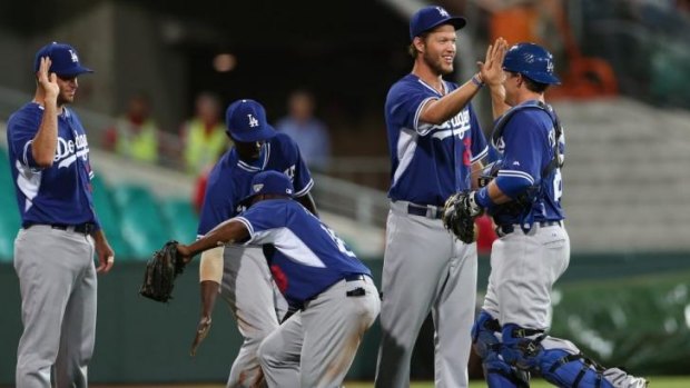 LA dodgers pitcher Clayton Kershaw and teammates celebrate their win.