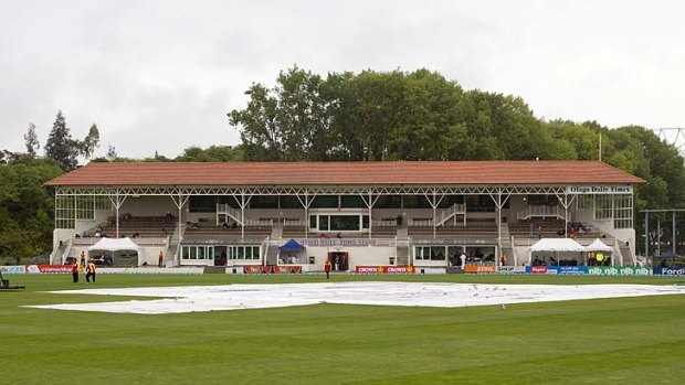 The University Oval is covered during a rain delay on the final day of the first Test between New Zealand and the West Indies.