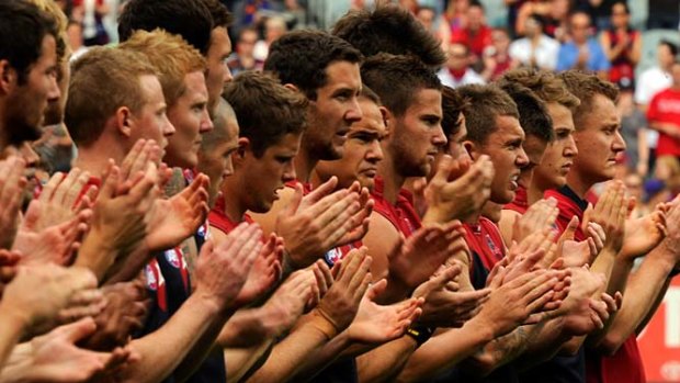 Melbourne pay tribute to Jim Stynes with a clap of hands before their game.