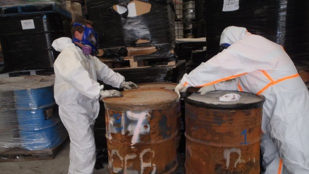 EPA officers with abandoned steel drums containing toxic material found in a warehouse in the northern Melbourne suburb of Campbellfield. 