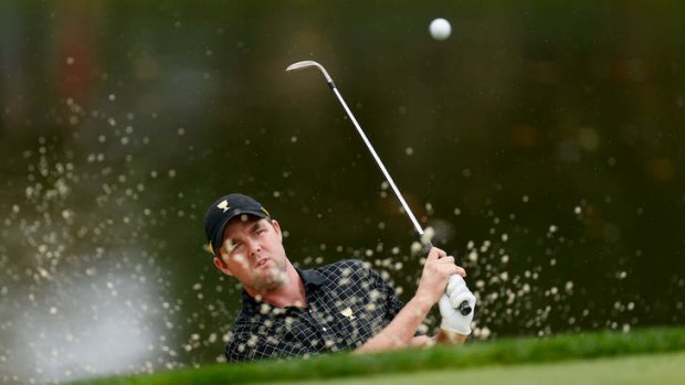 Australian Marc Leishman shoots from the bunker on the third hole.
