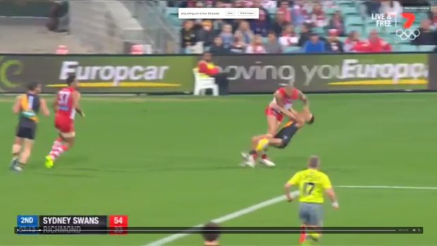 Shane Edwards is thrown backwards by the force of the contact with Lance Franklin.