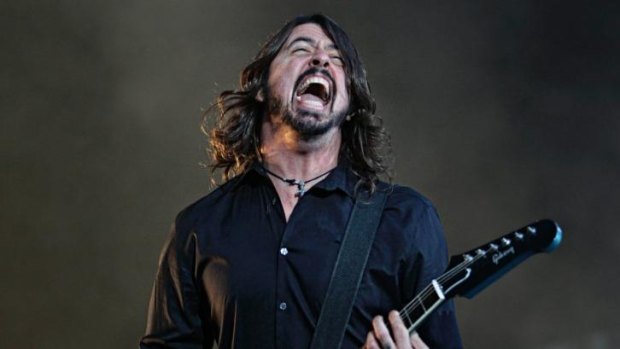 In fine form: Dave Grohl of Foo Fighters plays at Etihad Stadium on February 28.