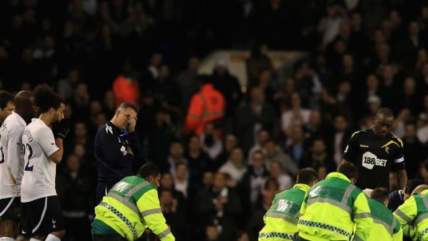Distraught  ... Bolton manager Owen Coyle, left, and players from both sides look on in disbelief as Fabrice Muamba gets medical attention on the pitch after collapsing during their FA Cup quarter-final with Tottenham at White Hart Lane on Saturday.