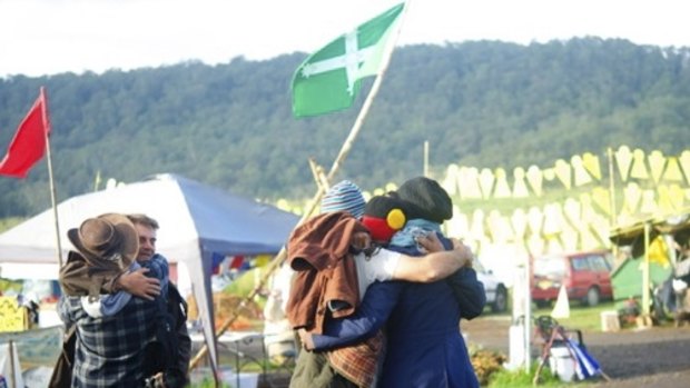 Hugs all round: protesters at the Bentley camp celebrate the drilling suspension. 