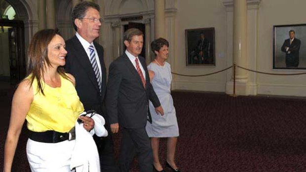 Ted Baillieu and wife Robyn with deputy Peter Ryan and wife Trish walk past portraits of past premiers in Queens Hall, Parliament House.