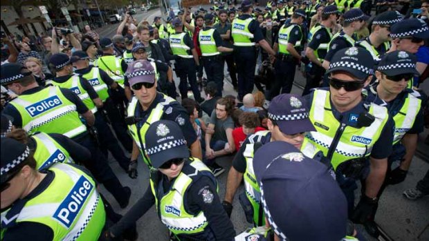 Police surround protesters on the Spring Street tram tracks.