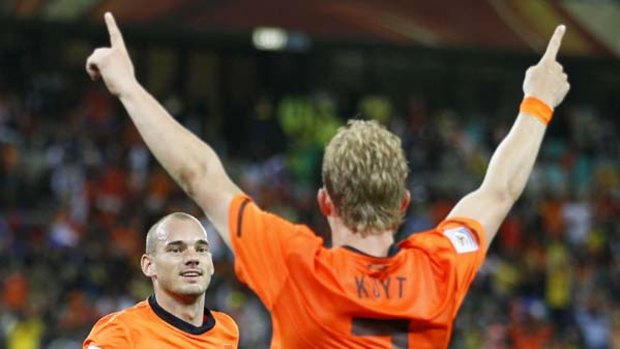 Netherlands' midfielder Wesley Sneijder runs up to striker Dirk Kuyt who provided him the cross to score the team's second goal.
