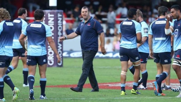Unruffled: Waratahs coach Michael Cheika with his team before the match against the Sharks.