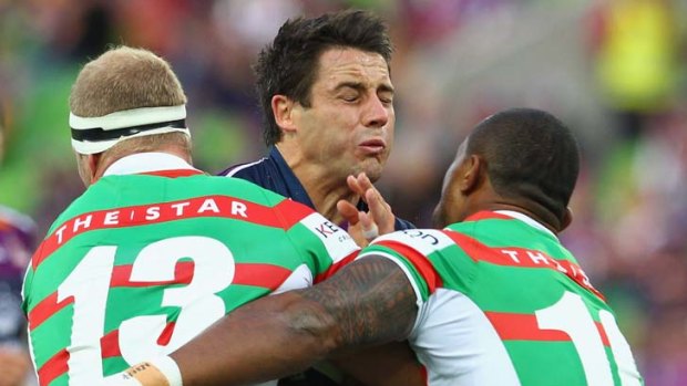 Cooper Cronk of the Storm is tackled by Michael Crocker and Roy Asotasi of the Rabbitohs.