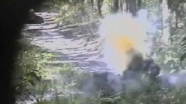 "Big, bad bombs" ... this still shows a bomb exploding in bushland after an undercover officer shows Abdul Benbrika how to detonate it.