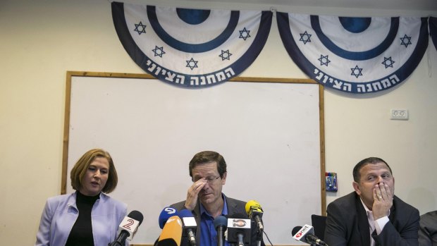 Tzipi Livni, left, and Isaac Herzog, centre, at their party headquarters on Wednesday after losing Israel's general election.